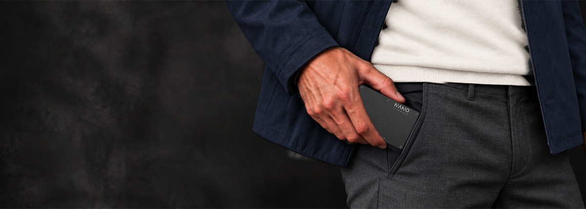 NANO Axiom Black Titanium wallet slipping into a trouser pocket.