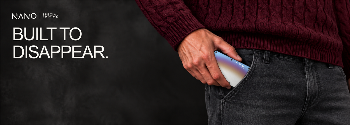 NANO Flame Burnt aerospace aluminium cash strap wallet — sliding into a trouser pocket