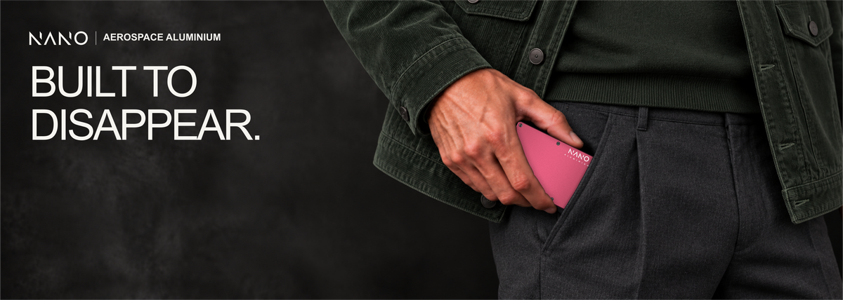 NANO Portofino Red aerospace aluminium cash strap wallet — sliding into a trouser pocket