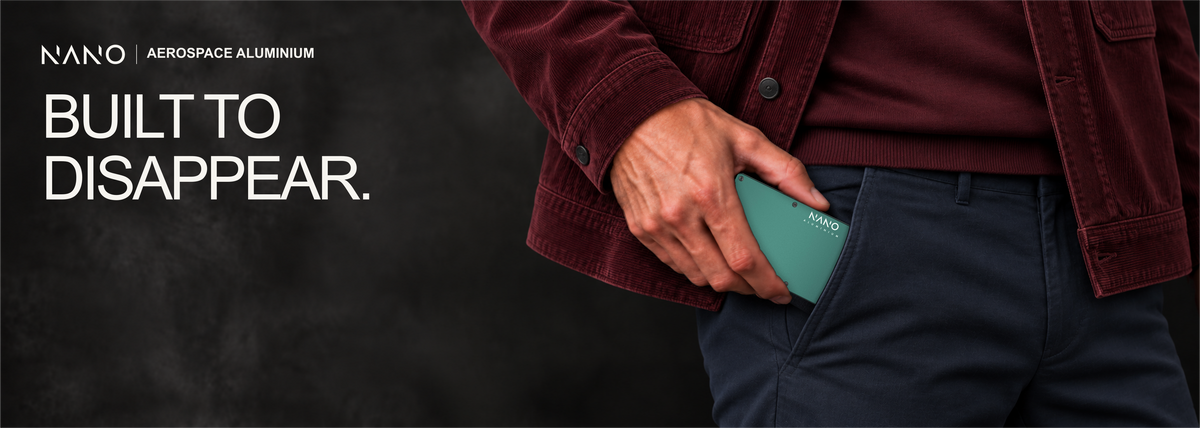 NANO Racing Green aerospace aluminium AirTag cash strap wallet — sliding into a trouser pocket