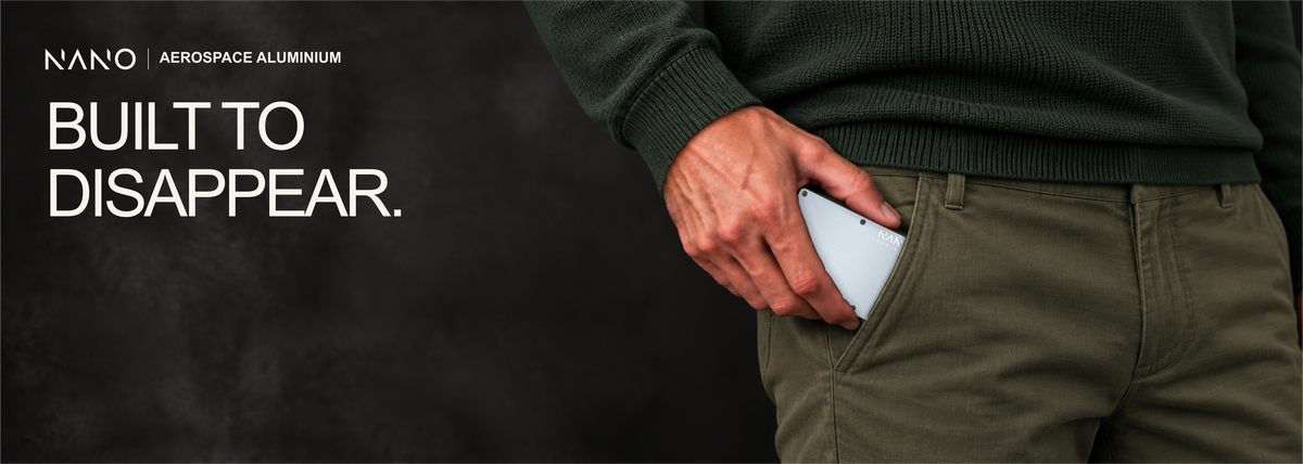 NANO Spyder Grey aerospace aluminium cash strap wallet — sliding into a trouser pocket