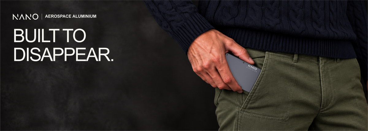 NANO Titan Gunmetal aerospace aluminium AirTag cash strap wallet — sliding into a trouser pocket
