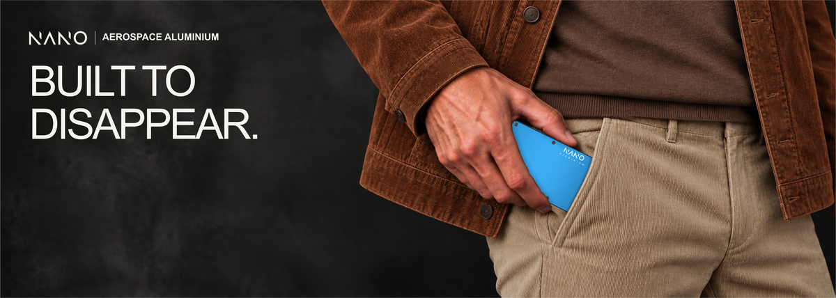 NANO Velocity Blue aerospace aluminium cash strap wallet — sliding into a trouser pocket