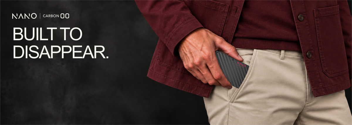 NANO Stealth Black 3K carbon fibre cash strap wallet — sliding into a trouser pocket
