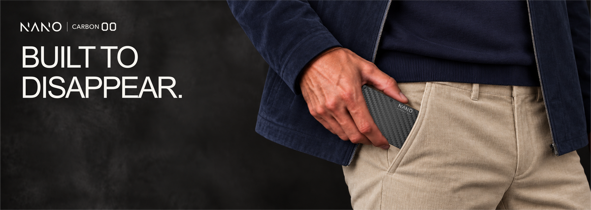 NANO Stealth Black 3K carbon fibre cash strap wallet — sliding into a trouser pocket