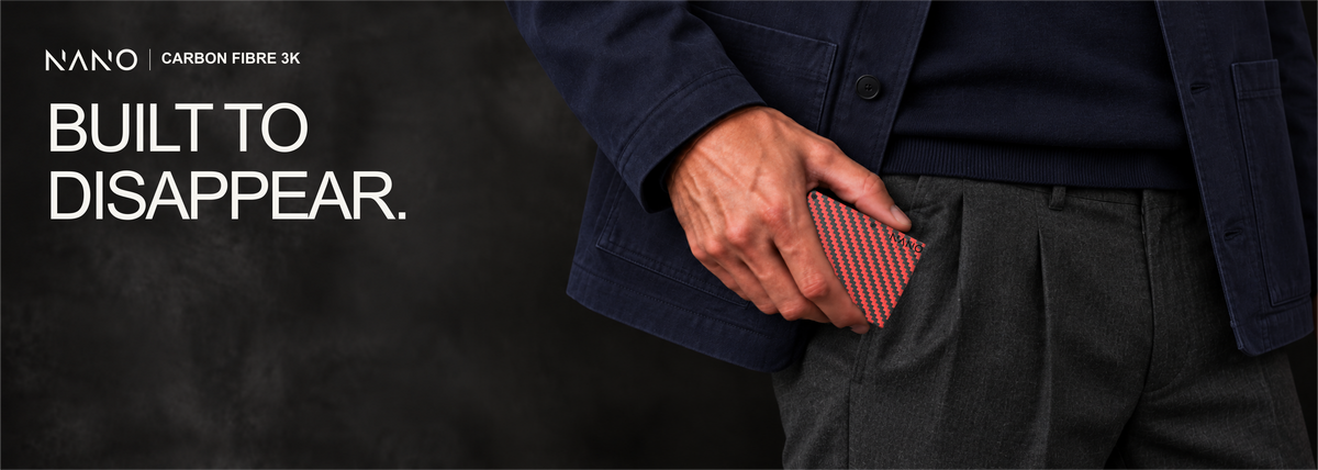 NANO Diablo Red/Stealth Black 3K carbon fibre AirTag cash strap wallet — sliding into a trouser pocket