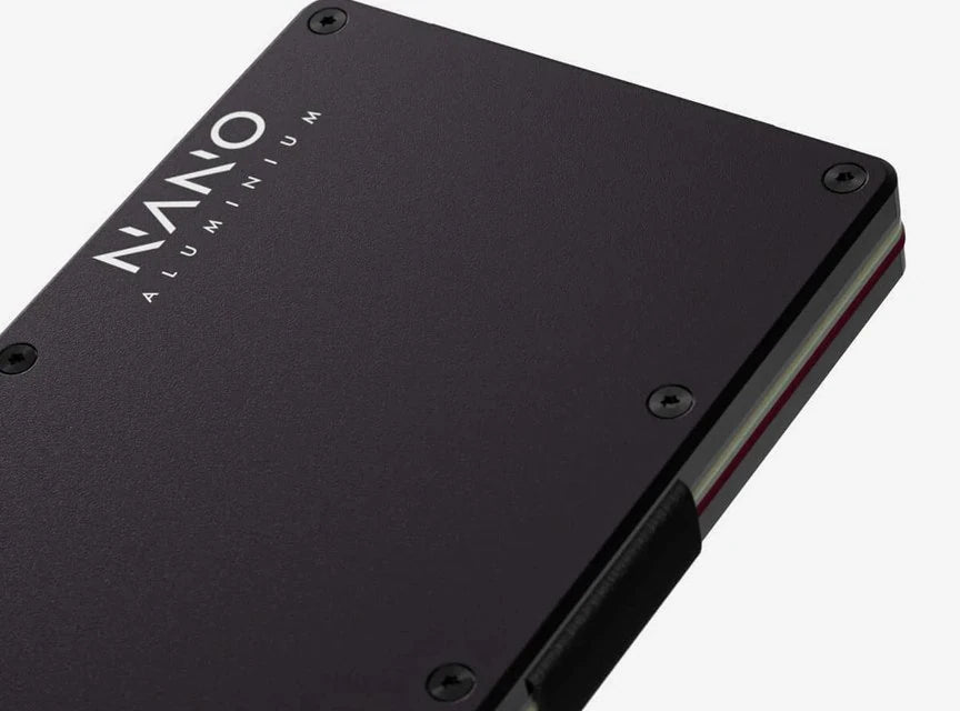 Close-up of the NANO aluminium wallet: anodised plates, precision screws and elastic card retention.
