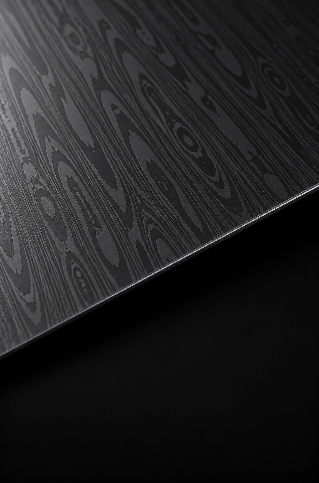 Damascus material study with a layered, flowing steel pattern.